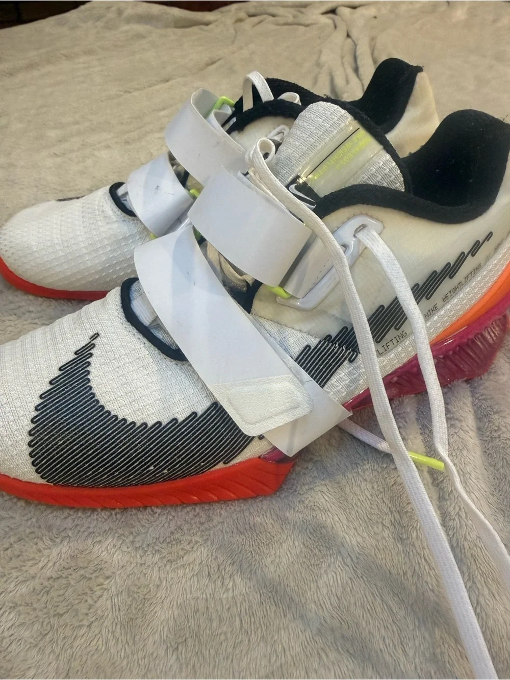 Nike White Athletic Shoes with Black Swoosh and Red Sole